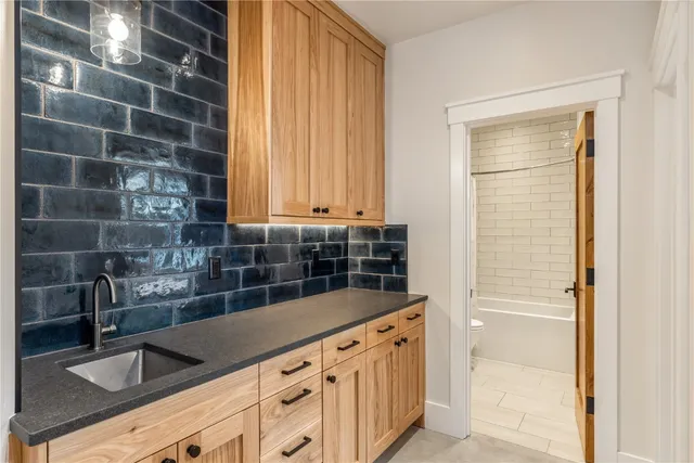 a kitchen with a sink and cabinets