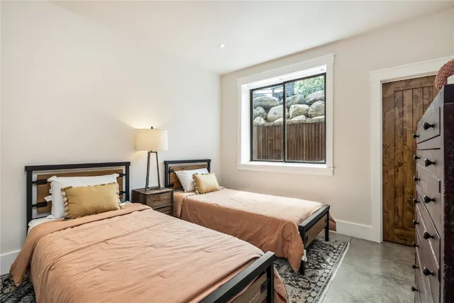 a bedroom with double bed and a window