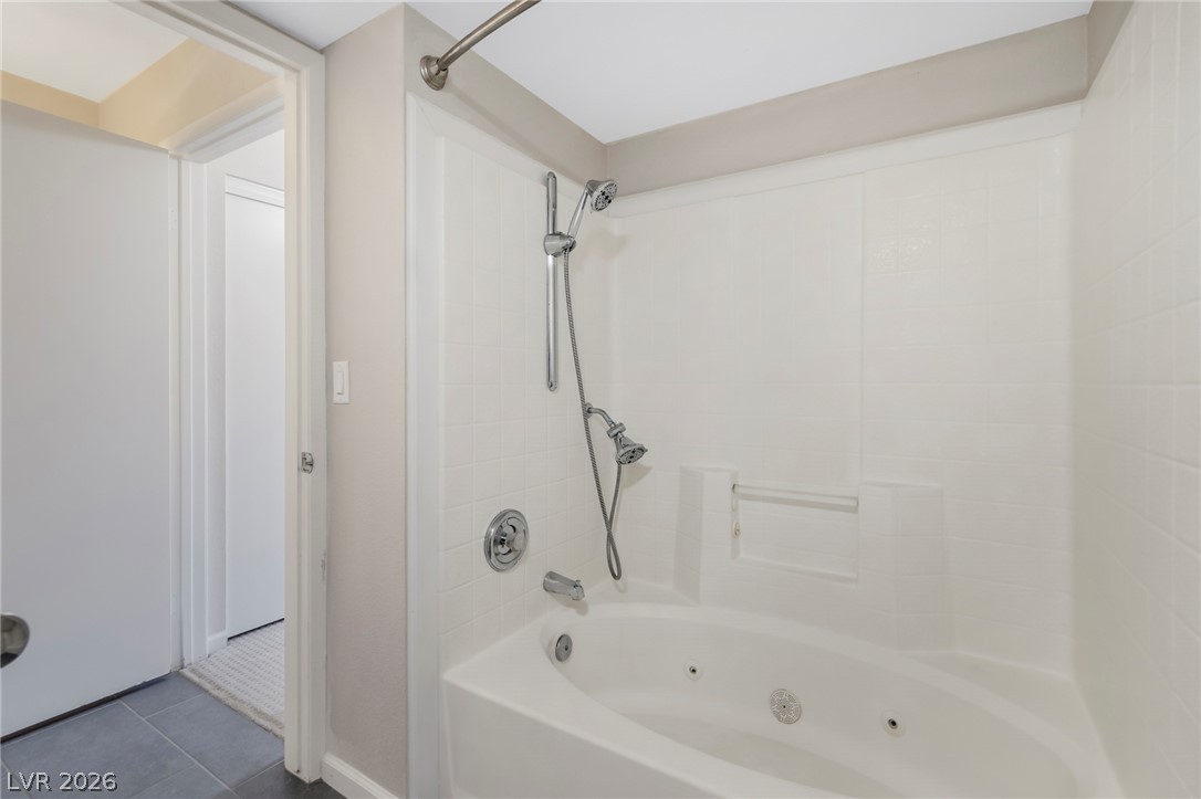 8070 West Russell Road, Unit 2006 Las Vegas, NV 89113 - Photo 16 of 24 Relax and rejuvenate in this inviting bathroom featuring a jetted tub and modern shower fixtures.