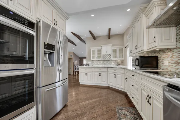 a kitchen with stainless steel appliances a stove microwave and a refrigerator