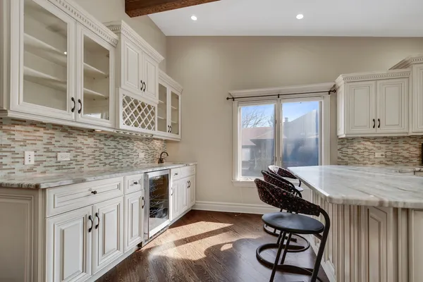 a kitchen that has a stove and a chair in it
