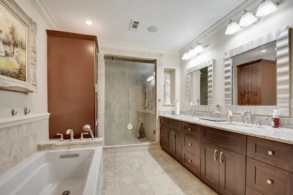 a bathroom with a tub sink and mirror