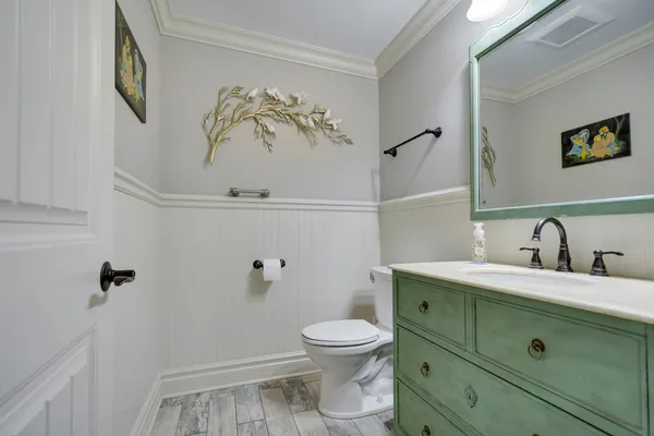 a bathroom with a toilet sink and mirror