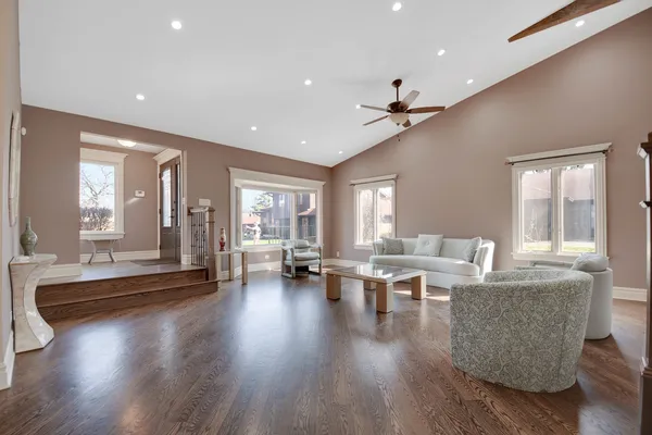 a living room with furniture and wooden floor
