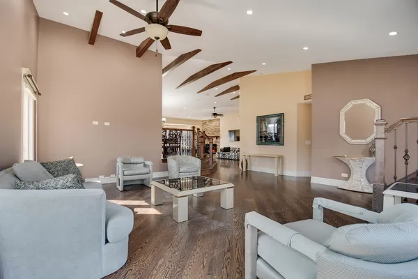 a living room with furniture and a wooden floor