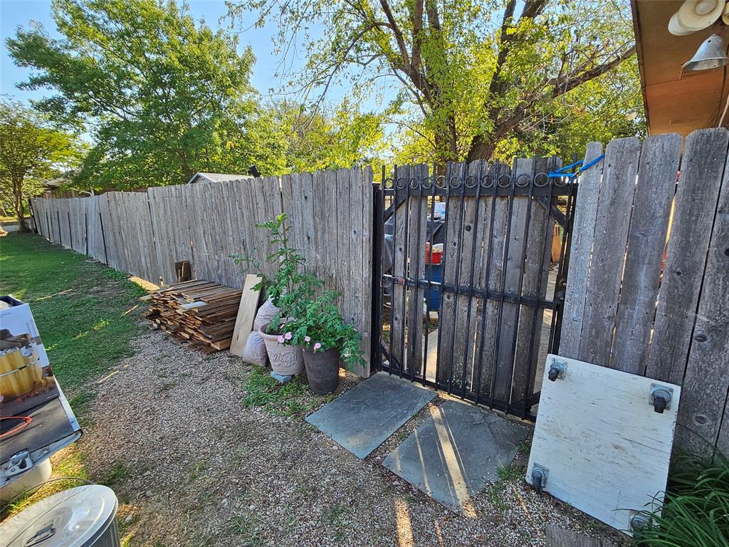 Tbd Tbd Mckinney Street Princeton, TX 75407 - Photo 4 of 7 a view of a backyard with wooden fence and a large tree