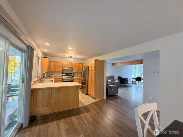 a kitchen with a refrigerator and a stove top oven