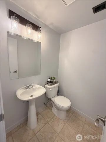 a bathroom with a sink a toilet and mirror