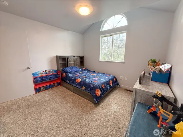 a bedroom with bed and window