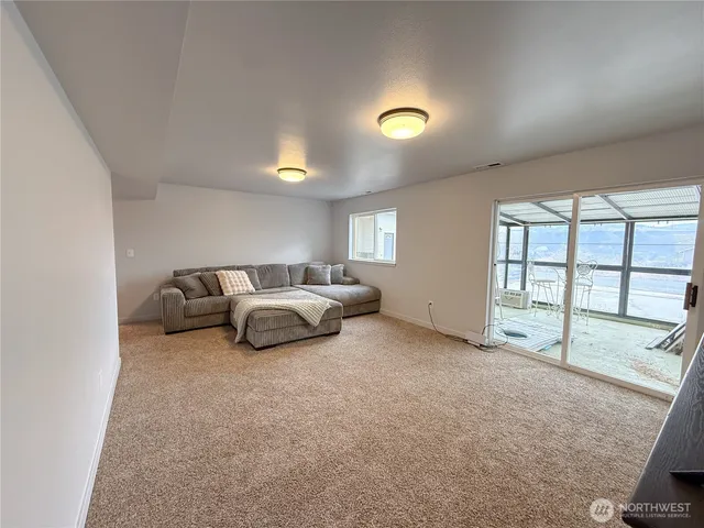 a spacious bedroom with a bed and a large window
