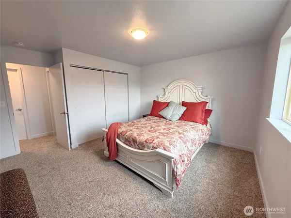 a bedroom with a bed and a window
