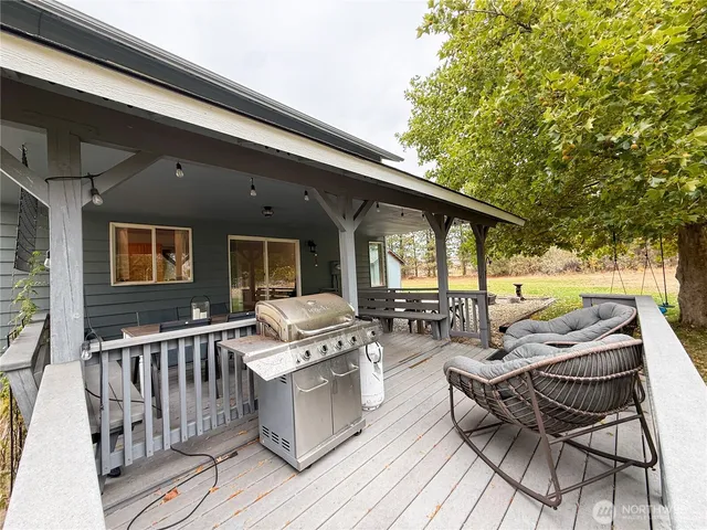 a view of a patio with couches table and chairs and wooden floor