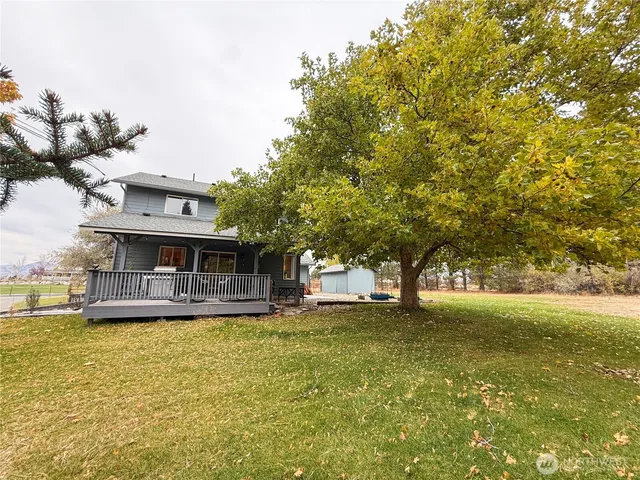 a view of a house with a yard and sitting area