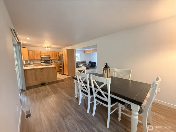 a view of a dining room with furniture and wooden floor