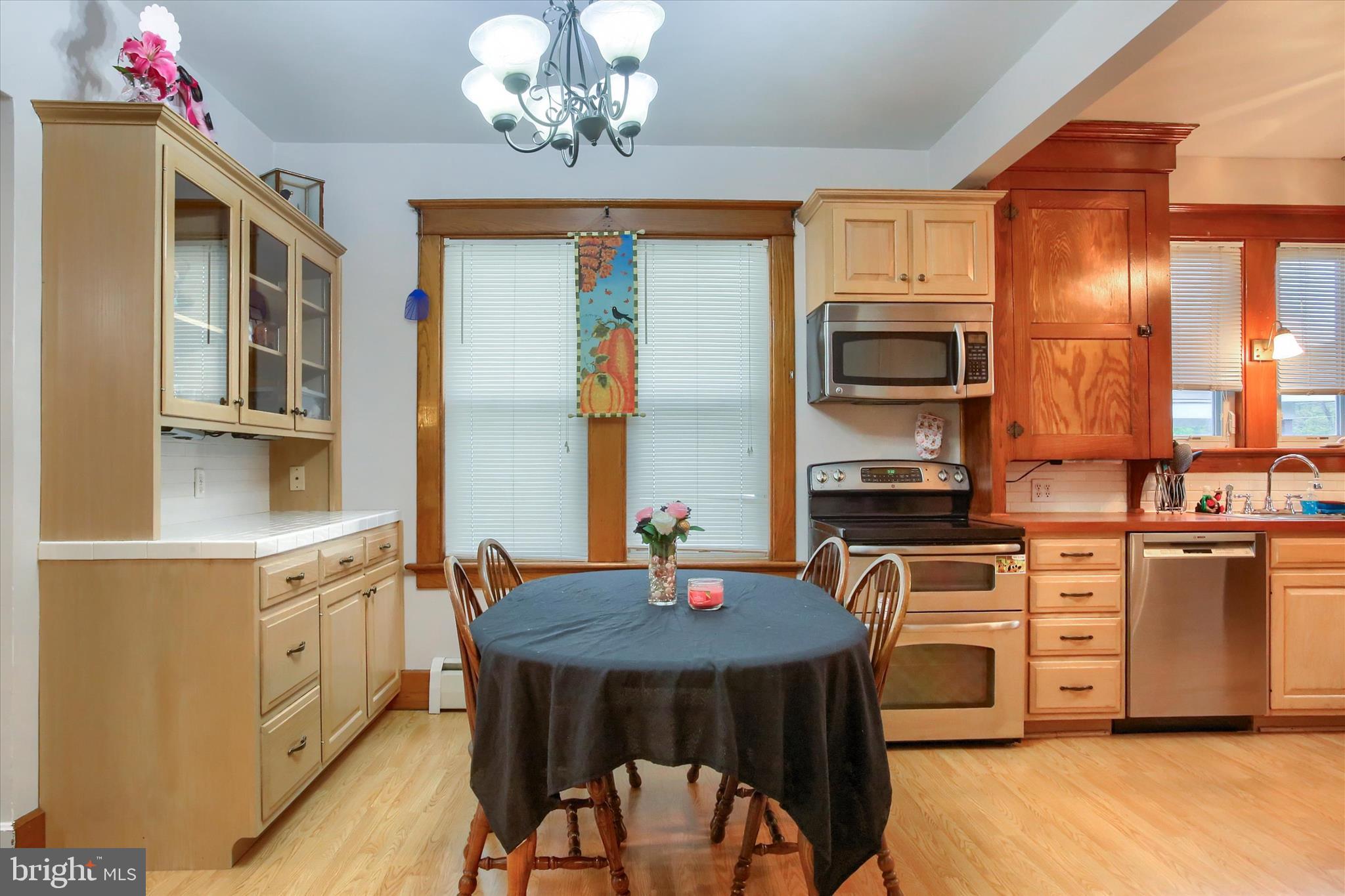 64 East Main Street Elizabethville, PA 17023 - Photo 6 of 29 a kitchen with stainless steel appliances a dining table chairs stove refrigerator and cabinets