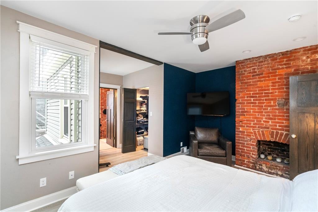 5208 Keystone Street Pittsburgh, PA 15201 - Photo 13 of 23 a bedroom with a bed and a fireplace