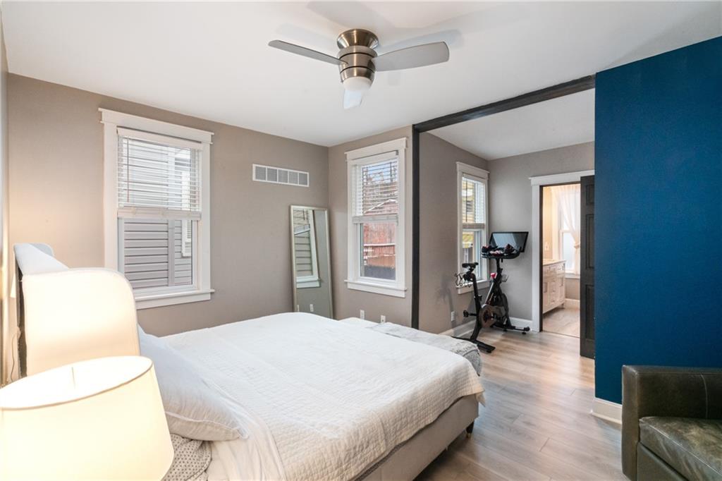 5208 Keystone Street Pittsburgh, PA 15201 - Photo 14 of 23 a bedroom with a bed and a chandelier