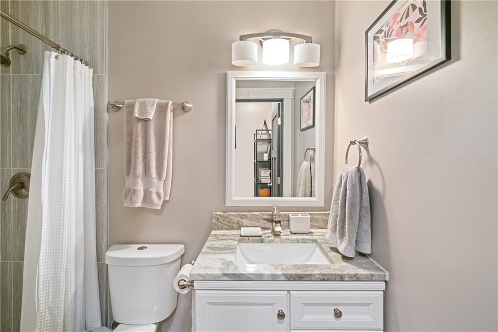 5208 Keystone Street Pittsburgh, PA 15201 - Photo 19 of 23 a bathroom with a granite countertop toilet sink and mirror