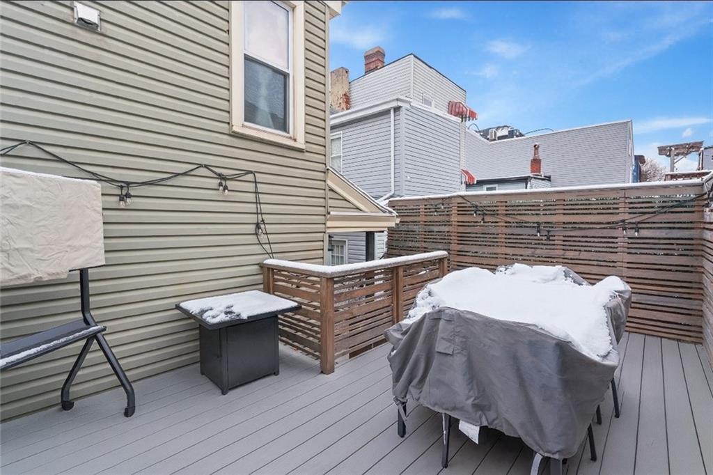 5208 Keystone Street Pittsburgh, PA 15201 - Photo 23 of 23 a view of a patio with table and chairs a barbeque with wooden floor and fence