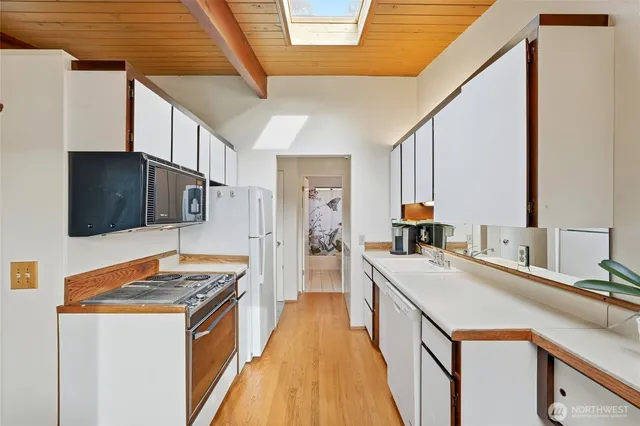 a kitchen with a sink stove and refrigerator