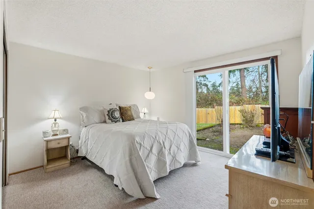 a spacious bedroom with a bed and a table