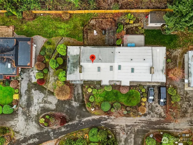 an aerial view of house with yard and outdoor seating