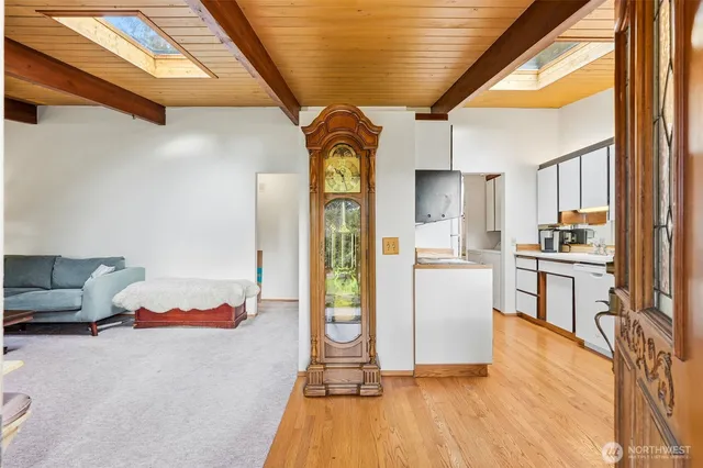 a kitchen with a refrigerator and wooden floor