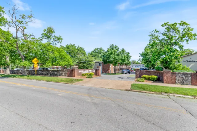 a couple of cars parked in front of a house