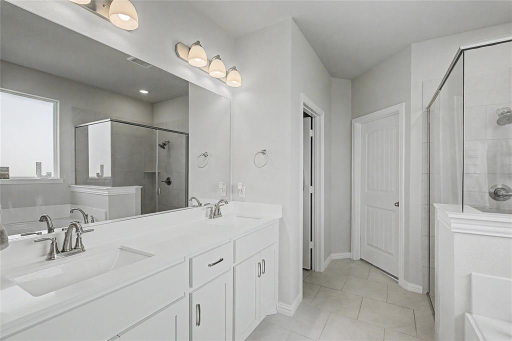 185 Chester Road Springtown, TX 76082 - Photo 24 of 40 Dual vanity with integrated sinks, brushed nickel fixtures, and ample counter space