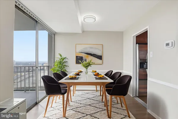 a view of a dining room with furniture and a potted plant