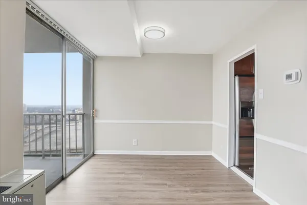 a view of an empty room with wooden floor