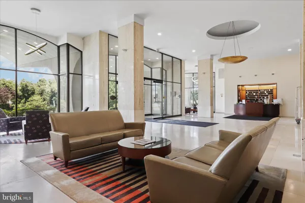an empty room with wooden floor and windows with curtains