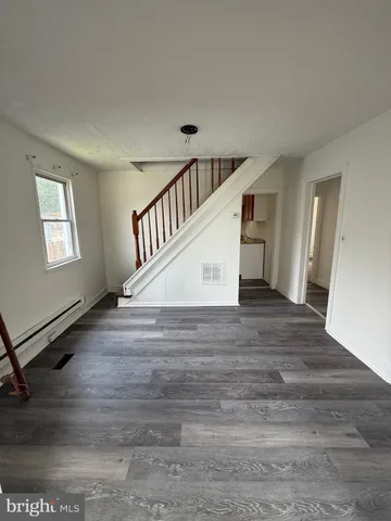 a view of entryway and hall with wooden floor