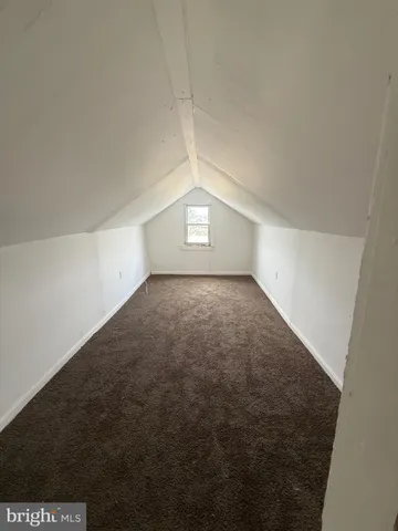 an empty room with a empty space and windows