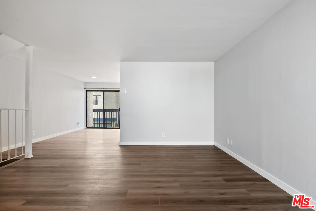 29239 Heathercliff Road, Unit 12 Malibu, CA 90265 - Photo 9 of 32 a view of an empty room with wooden floor and a window