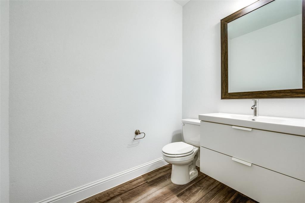 7336 Panicum Drive Frisco, TX 75033 - Photo 12 of 25 a bathroom with a toilet sink and mirror
