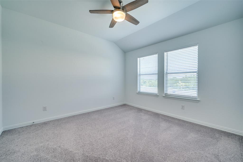 7336 Panicum Drive Frisco, TX 75033 - Photo 14 of 25 an empty room with a window and a fan