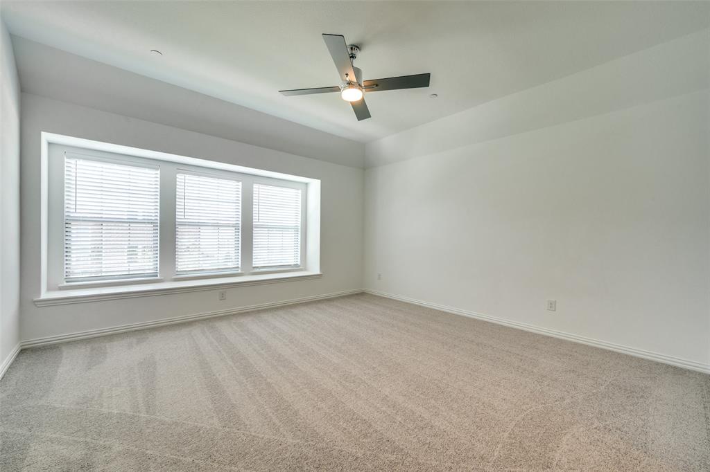 7336 Panicum Drive Frisco, TX 75033 - Photo 20 of 25 an empty room with a window and a ceiling fan