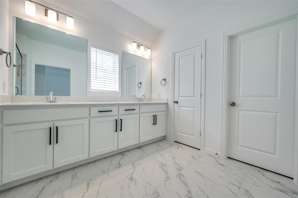 7336 Panicum Drive Frisco, TX 75033 - Photo 23 of 25 a view of a kitchen with white cabinets