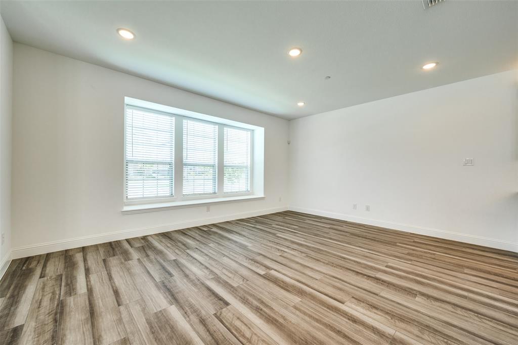 7336 Panicum Drive Frisco, TX 75033 - Photo 3 of 25 a view of an empty room with wooden floor and a window
