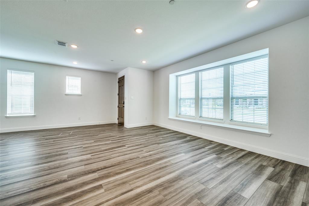 7336 Panicum Drive Frisco, TX 75033 - Photo 4 of 25 a view of an empty room with wooden floor and a window