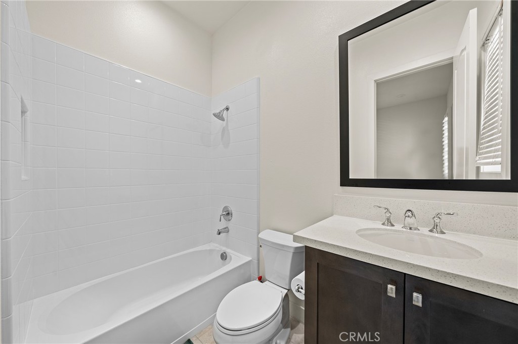 52 Eider Run Irvine, CA 92618 - Photo 18 of 46 a bathroom with a toilet a sink a mirror and bathtub