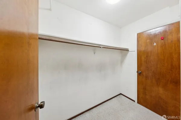 a bathroom with a granite countertop sink toilet a mirror and a vanity