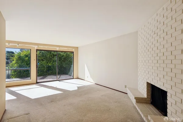 a view of an empty room with a fireplace