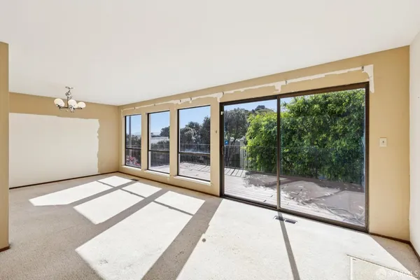 a living room with a large window and yard