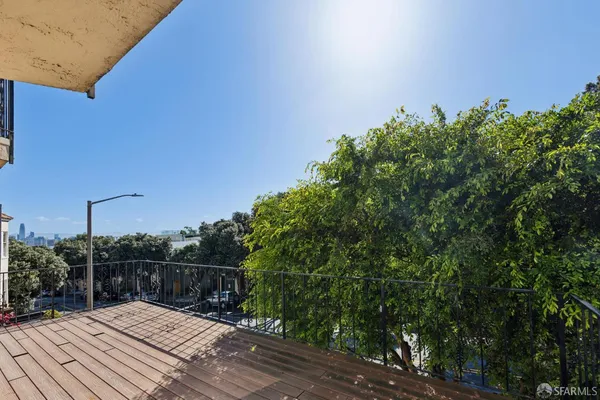 a view of balcony with wooden floor and fence