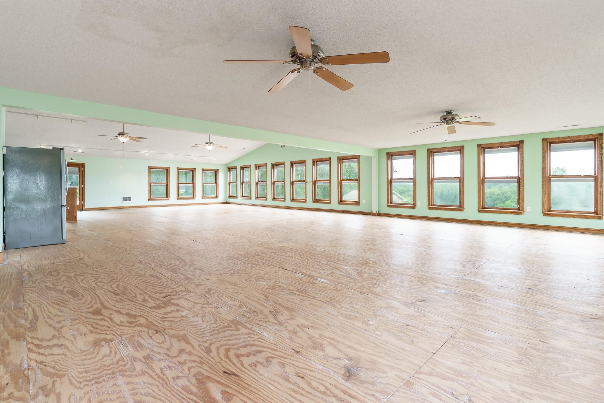 7979 Elevator Road Roscoe, IL 61073 - Photo 28 of 72 a view of an empty room with a window and wooden floor