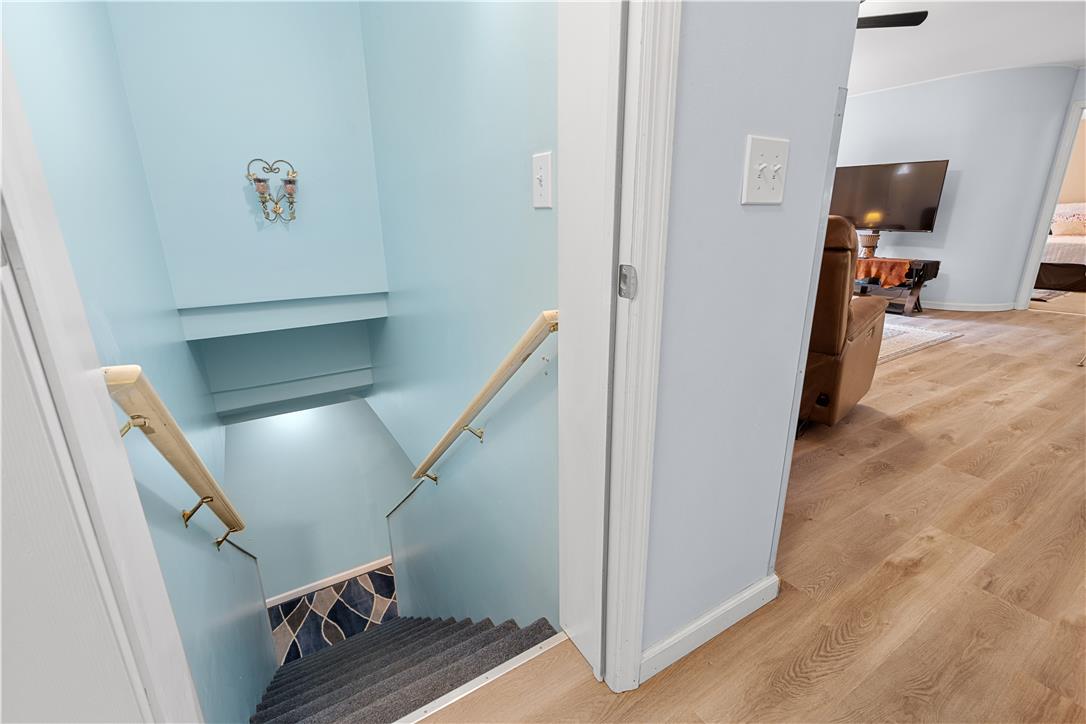 7353 Farrier Road Orefield, PA 18069 - Photo 49 of 74 Smooth wood-look flooring connects the main living spaces to a carpeted staircase.