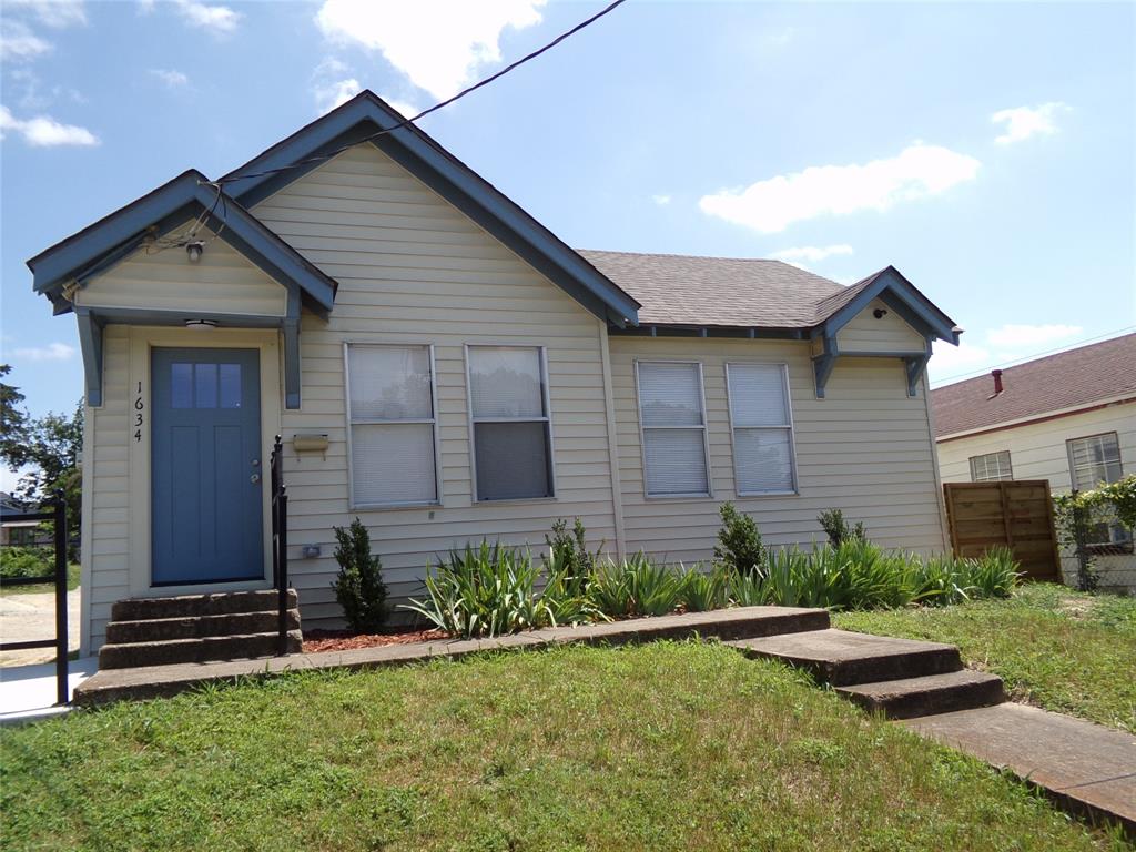 1634 Kyle Avenue Dallas, TX 75208 - Photo 1 of 1 a front view of a house with a yard