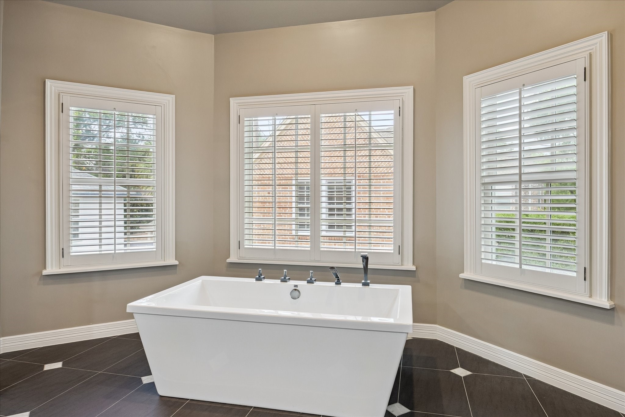 6358 Auden Street Houston, TX 77005 - Photo 24 of 50 a bath tub sitting in a bathroom next to a window